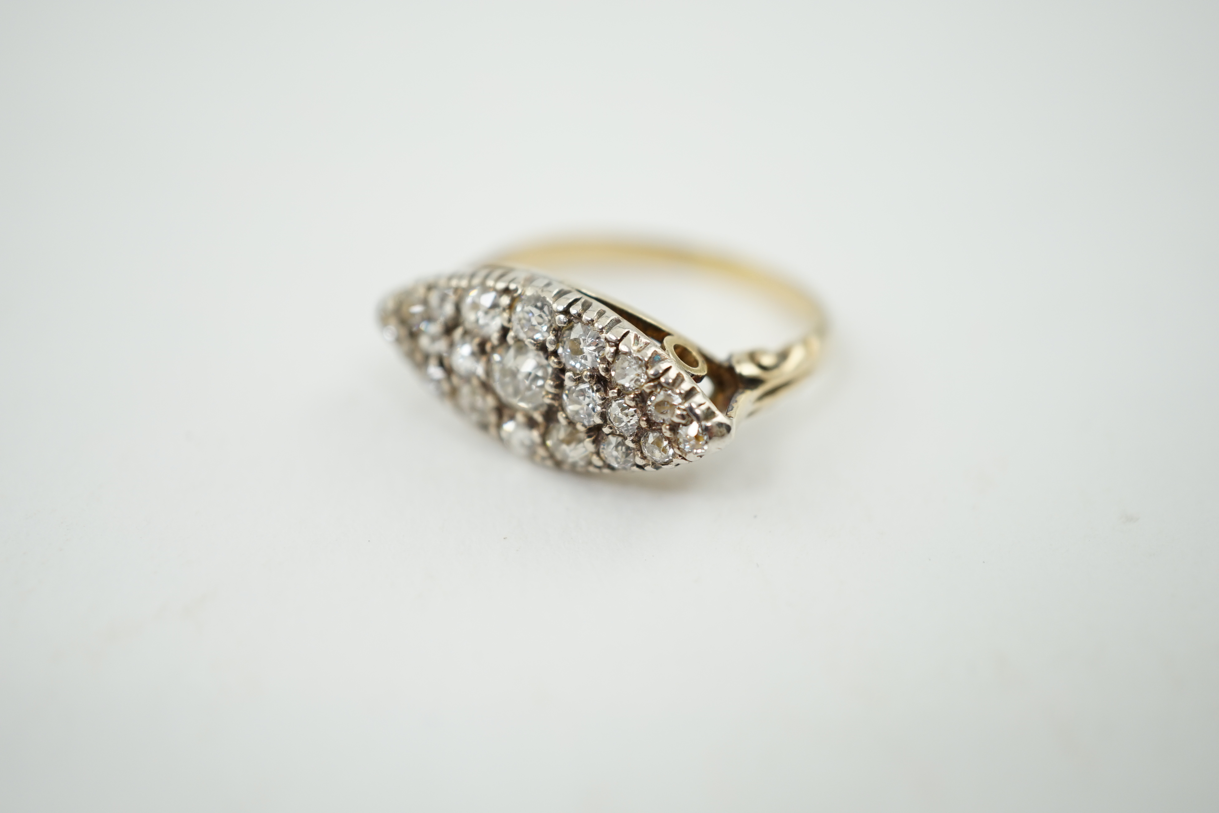 An early 20th century gold and diamond cluster set navette shaped ring